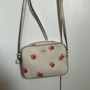Coach purse with pink flowers. Length: 7.5 inches, Width: 6 inches.